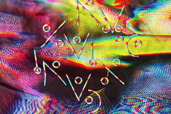 A detail image of a digital textile with machine embroidery and asemic symbols by artist Kate Geck for the Enfolded Emblems project. A series of textile art panels digitally printed and machine embroidered, embedded with augmented reality markers that pop contemplative content like guided meditations and relaxing gifs.